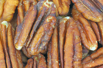 Very close view of a layer of pecan nuts.