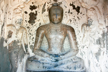 Statue in ancient rock temples at Ajanta ,  India