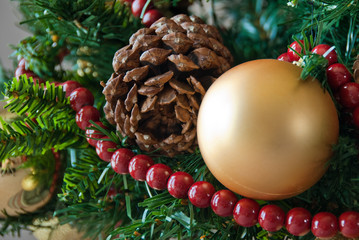 Close-up of Christmas tree decorated with cone, yellow ornaments