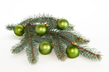 Single branch of evergreen decorated with green ornaments
