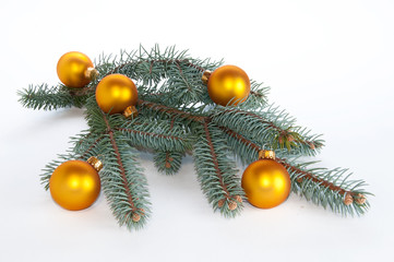Single branch of evergreen decorated with yellow ornaments