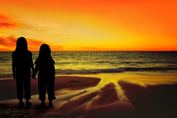 Silhouettes of Children on a sunset beach