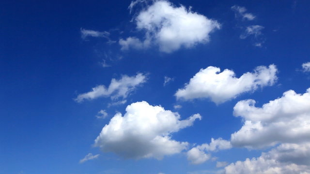 Time lapse, white fluffy clouds over blue sky