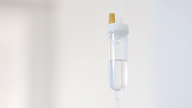 Intravenous drip on white background in operation room