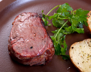 Grilled beef on white plate with potatoes