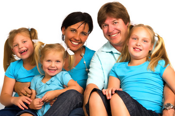 portrait of a young family with their three daughter smiling