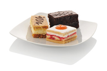 Fototapeta na wymiar cakes on a white plate isolated on white