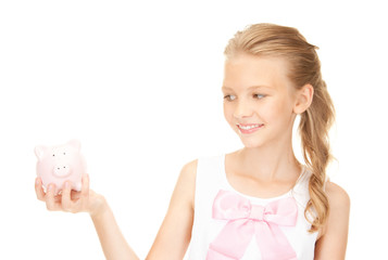 lovely teenage girl with piggy bank