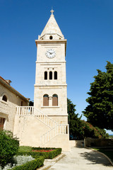 Fototapeta na wymiar small romantic historical church trust with clock