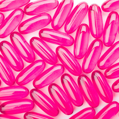 Pink capsules on white background