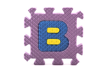 Alphabet puzzle pieces on white background