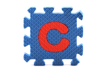 Alphabet puzzle pieces on white background