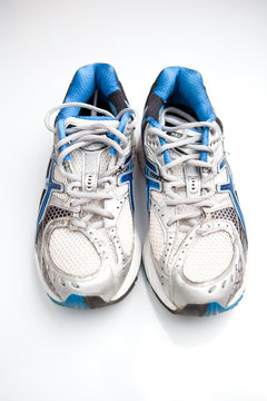Pair of running shoes on a white background. (shallow DOF; color