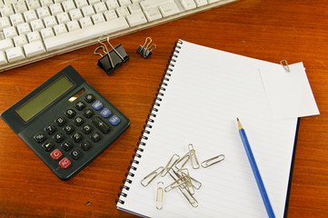 paper clip papernote notebook pen pencil keyboard and calculator