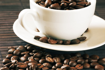 Coffee beans and cup close-up