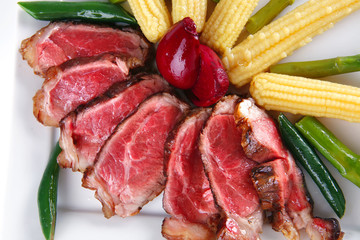 meat served on white with corns