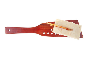 cream cake on wooden spatula