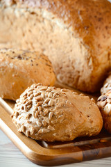 Composition with bread and rolls on kitchen table