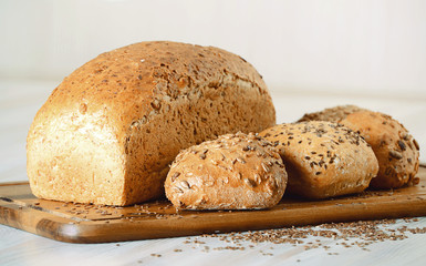 Composition with bread and rolls on kitchen table