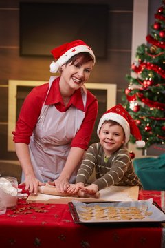 Happy mum baking with son for christmas