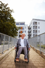 Lachende Rollstuhlfahrerin auf Rampe