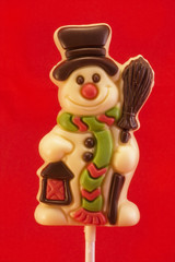 white chocolate snowman lolly over red