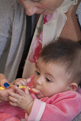 Fototapeta premium Baby Girl eating with her Mother