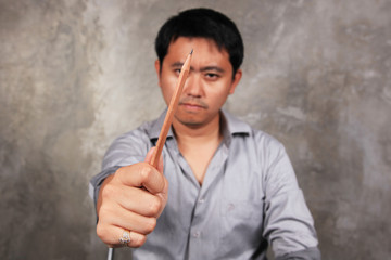a man aim a pencil