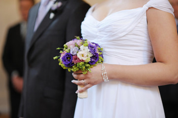 Bride holding blue flowers