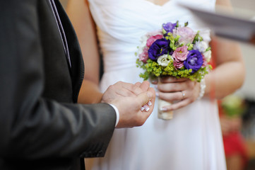 Groom holding bride's hand