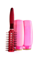 Shampoo bottles and hair brush   on white