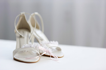 Elegant bridal shoes and a garter