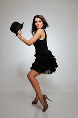 sexy fashion dancing woman in black dress with evening make-up a