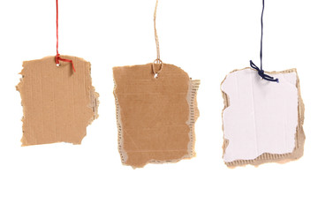 three cardboard tags hanging on white background