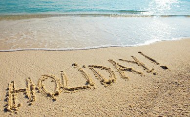 Holiday - it is written on sand before a wave
