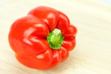 red pepper on a cutting board isolated on white