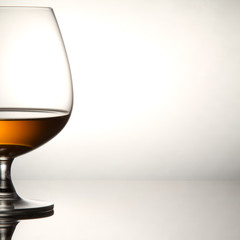 Glass of brandy over white background