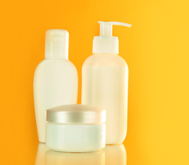 bottles of health and beauty products on yellow background
