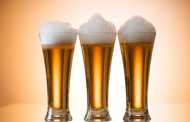 Beer glasses against the colorful gradient background