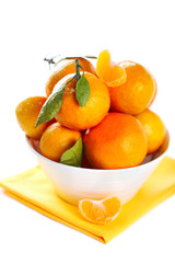 Tangerine in bowl on white isolated background