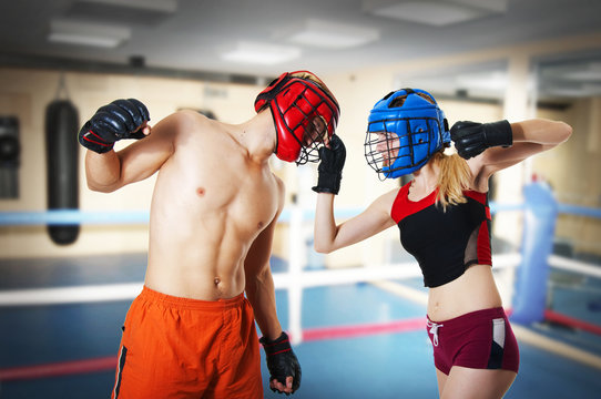 Two person training kikboxing on ring