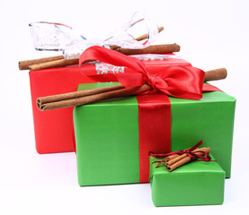 Gift with bows decorated with cinnamon sticks on white