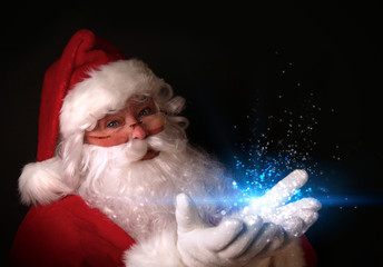Santa holding magical lights in hands - 27887119