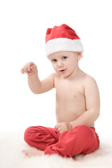 Santa claus baby in studio is pointing