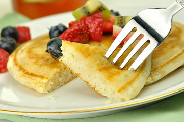 pancake with maple syrup,honey and berries