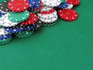 Poker chips on a green felt poker table