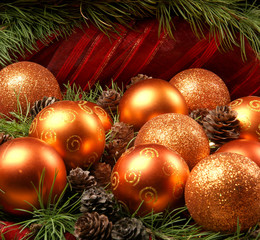 Colorful Christmas balls and cones on spruce branches