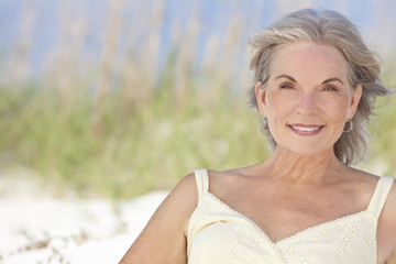 Attractive Elegant Senior Woman Sitting At A Beach