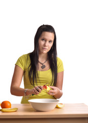 Beautiful young woman  preparing a fruit salad