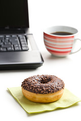 break in the  office . doughnut on laptop keyboard